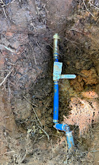 Underground water line repair — blue PVC service line